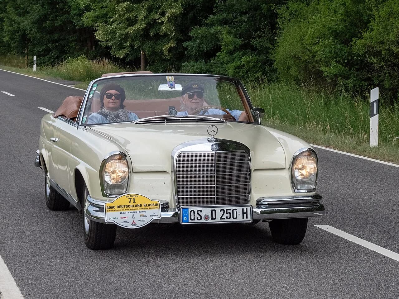 A distinctive Mercedes convertible touring on an open road