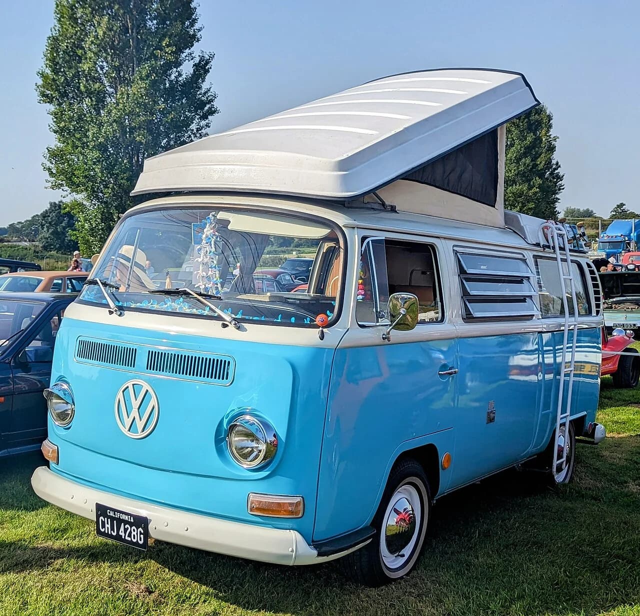 Turquoise and white 1969 Volkswagen T2 bay-window camper bus
