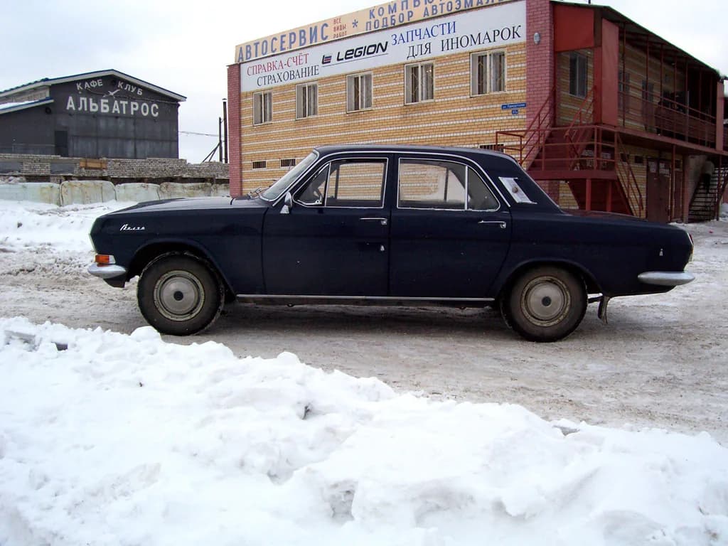Black Soviet-era GAZ Volga sedan on a city street