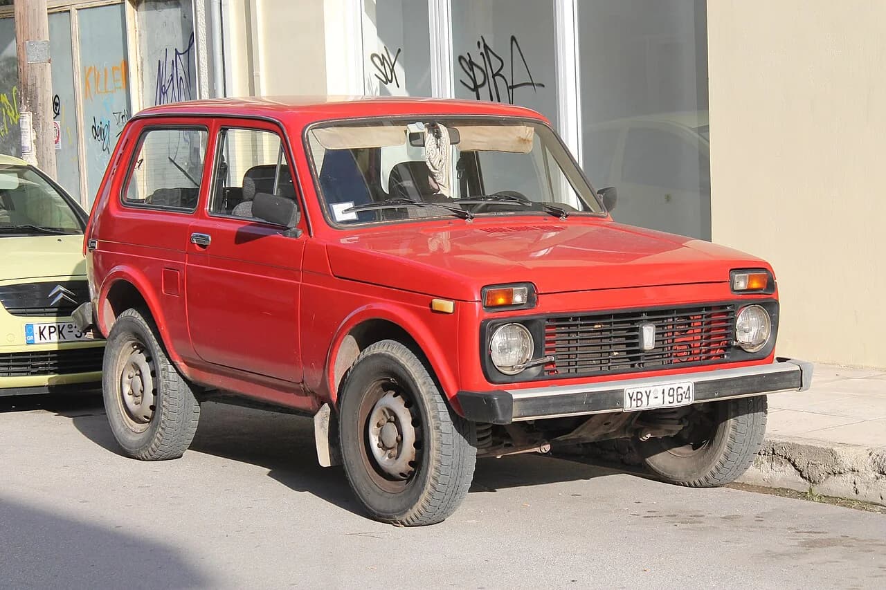 Brick-red Lada Niva 1600 photographed from the front three-quarter